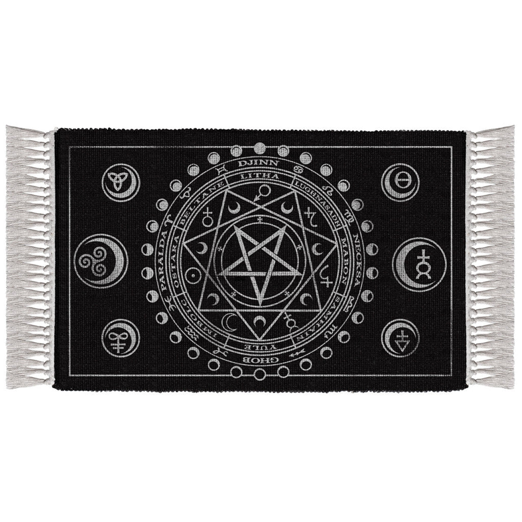 Black rug with white fringe featuring central pentagram design and various symbols on a white background